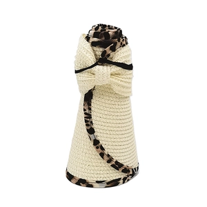 Detail showing foldable sun visor hat with leopard bow and straw texture in cream