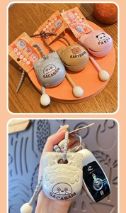 Detail view of silicone Capybara and Panda keychains with matching elastic lanyards