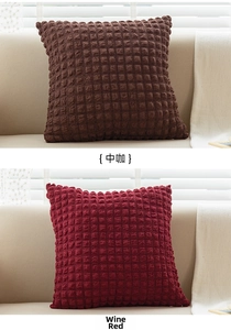 Close-up of square pillows in brown and burgundy with textured bubble grid fabric