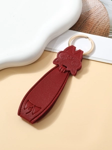 Detailed macro view of a red PU leather cat keychain with a premium golden metal ring