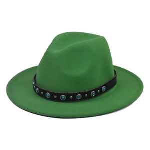 Close-up of green wool fedora with black band featuring turquoise beads and silver studs