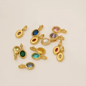 Close-up of colorful oval gemstone pendants with gold-plated stainless steel settings