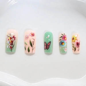 Pastel floral and butterfly press-on nails with colorful garden design on white tray