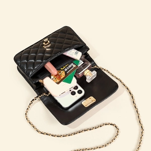 Classic black quilted shoulder bag with chain strap showing spacious interior capacity
