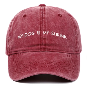 Close-up of white My Dog Is My Shrink embroidery on vintage washed burgundy baseball cap