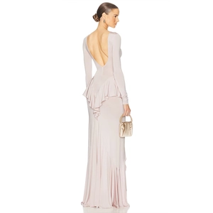 Detail of elegant backless light pink gown with ruffles and floor-length slit design