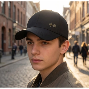 Detail of black baseball cap with golden Chinese character emblem in sunset lighting