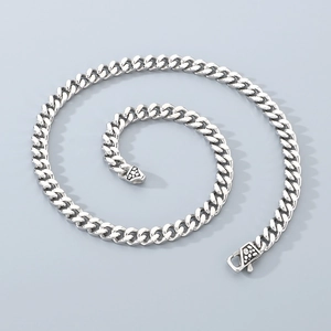 Macro detail of 8mm silver Cuban chain with vintage textured lobster clasp and flat links
