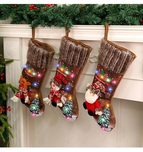 Three lit Christmas stockings with 3D Santa, Reindeer, and Snowman on a fireplace mantle