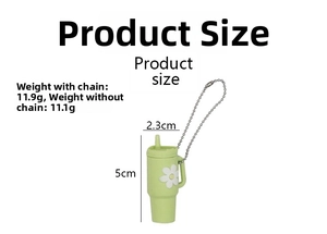 Detail view of mini green straw cup keychain with dimensions 5cm height and daisy patterns