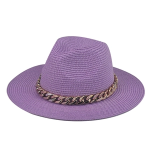 Detail view of purple straw fedora hat featuring a chunky rose gold chain decoration
