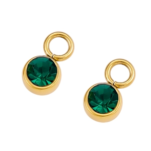 Detailed close-up of dark green round gemstones in polished gold metal settings