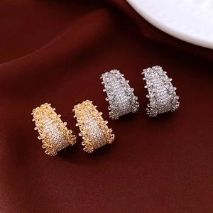 Detail of 14K gold and silver plated C-shaped hoop earrings with shimmering pave crystals