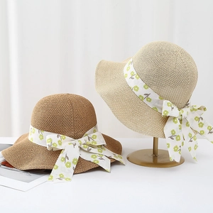 Breathable woven straw sun hat for women with floral ribbon and bow in beige and khaki