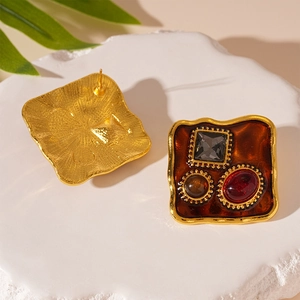 Detailed front and back view of vintage resin earrings with inlaid colorful gemstones