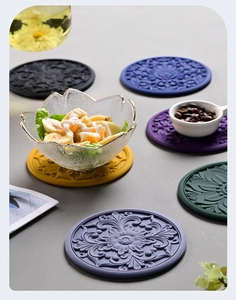 Flat lay of colorful heat-resistant silicone table mats with floral embossed patterns
