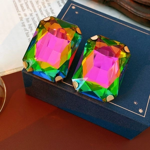 Macro shot of rectangular rainbow crystal earrings with vintage gold claw setting