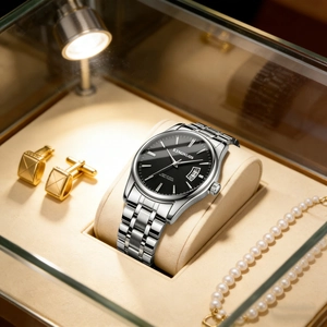 Detail view of silver stainless steel watch with black dial and date window on watch pillow