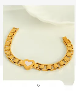 Detailed macro view of 18K gold-plated stainless steel chain with shell heart pendant