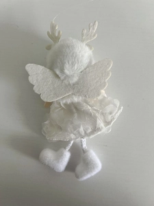 Detail of white plush Christmas angel reindeer ornament with lace wings and antlers