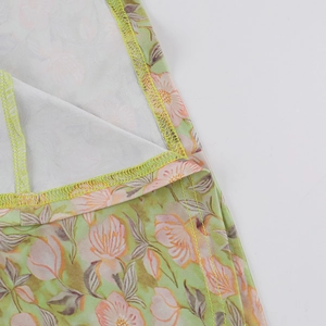Gros plan sur tissu imprimé floral avec fleurs roses et détails de couture overlock de qualité