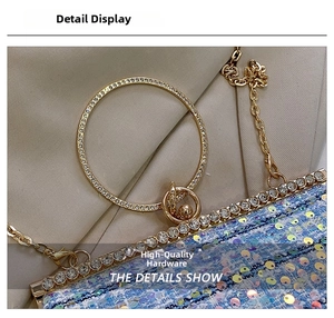 Close-up of sparkling blue sequins, crystal-studded round handle and gold chain strap