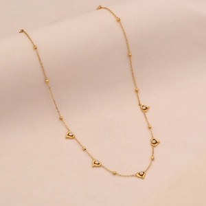 Elegant gold stainless steel necklace with small beads and sparkling heart pendants