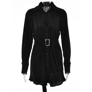 Detailed macro view of black pleated fabric texture with silver buckle on the waist belt