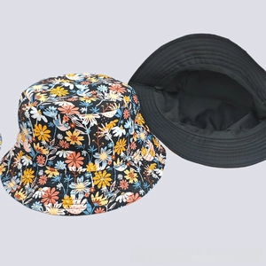 Flat lay of floral digital print bucket hat showing colorful flower pattern on black fabric