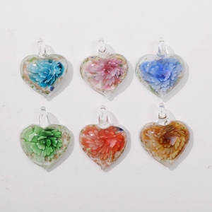 Macro shot of colorful heart-shaped glass flower pendants in assorted pastel tones