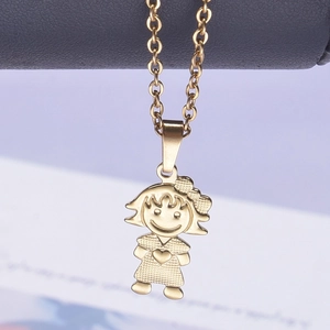 Macro shot of 18k gold plated stainless steel girl pendant with bow and heart details
