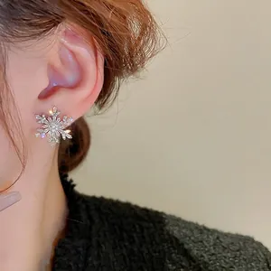 Silver snowflake earrings with sparkling cubic zirconia crystals and a pearl accent