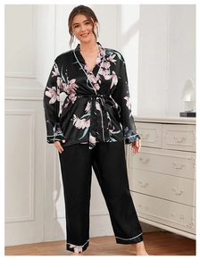Detail of plus size black satin pajama set with floral print and tie-waist cardigan