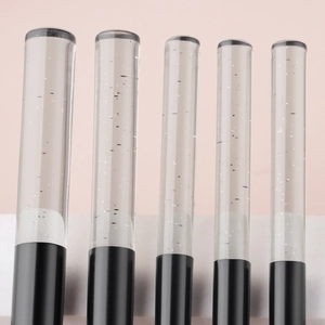 Detail of 5-piece mini makeup brush set featuring crystal glitter acrylic handles and black base