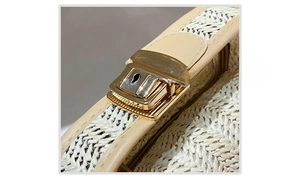 Detailed close-up of the golden metal push-lock and woven straw texture on bag