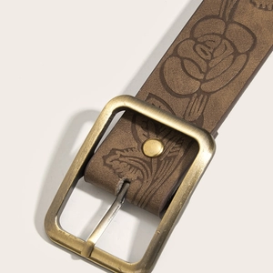 Brown vintage leather belt with brass buckle and embossed floral patterns