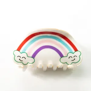 Rainbow claw clip with smiley clouds and colorful stripes for elegant hair styling