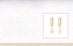 Macro detail of S925 sterling silver hoop earrings with baroque pearl drop and zircon
