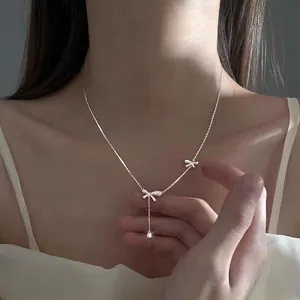 Elegant S925 sterling silver necklace featuring double bows and a zircon tassel pendant