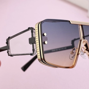 Close-up of gold metal frame with mesh texture and blue-tea gradient lens