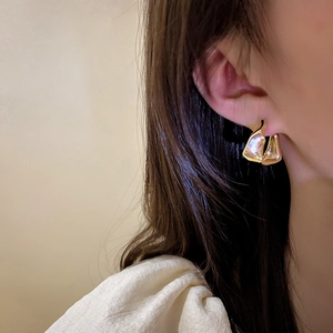 Minimalist irregular gold geometric earrings with lava texture for women on model