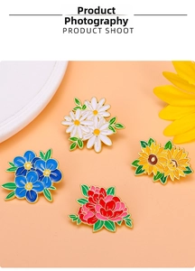 Detailed view of colorful enamel flower brooches featuring daisy and sunflower on golden alloy