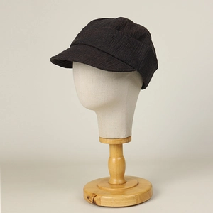 Linen newsboy octagonal hat for women in dark coffee textured fabric on wooden stand