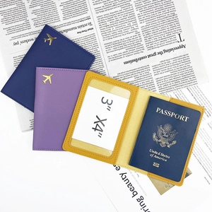 Multi-color faux leather passport cover with gold airplane logo and ID window
