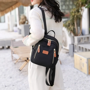 Chic black nylon women's backpack with brown leather details for daily commuting