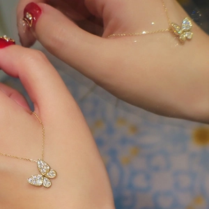 Elegant gold butterfly pendant necklace with sparkling pavé stones on a minimalist chain