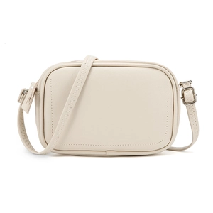 Close-up of cream square crossbody bag with decorative wavy stitching on the strap