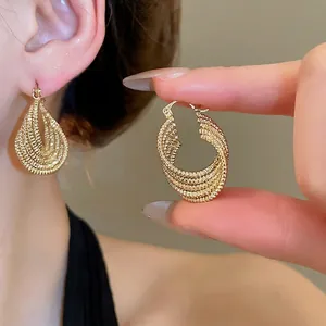 Textured gold layered twisted oval hoop earrings for a luxury vintage minimalist look