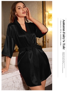 Detailed view of smooth black satin robe with kimono collar and silky waist tie