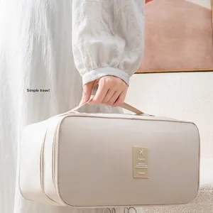 Portable beige travel organizer bag for underwear and bras with waterproof fabric